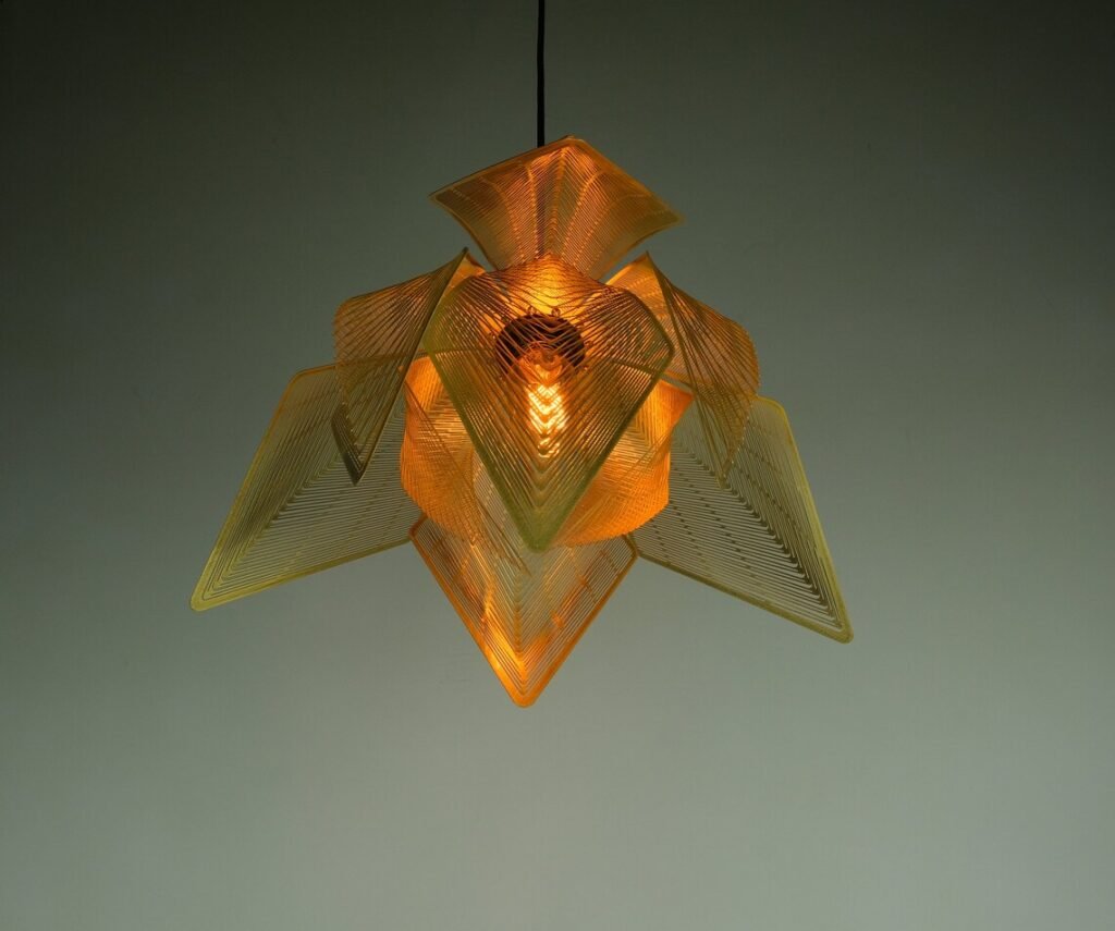 A cozy workshop setting with various leather goods and accessories on display. Handcrafted items such as wallets, bags, and keychains are neatly arranged on a wooden table. There is a sewing machine in the background, along with hanging lamps that provide warm lighting. The ambiance suggests a focus on craftsmanship and artisanal work.